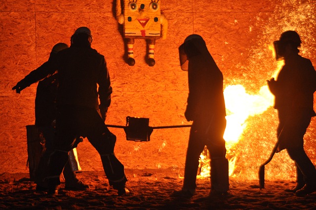 foundry workering in PPE carrying hot metal for blog by Emelin on furnace insulation basics